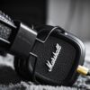selective focus photography of marshall corded headphones