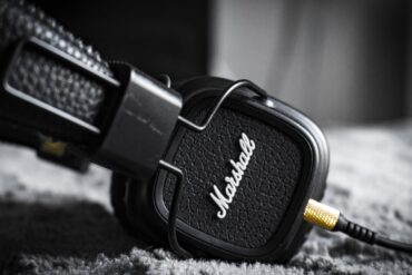 selective focus photography of marshall corded headphones