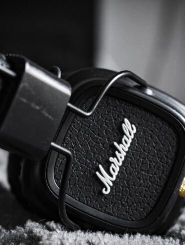 selective focus photography of marshall corded headphones