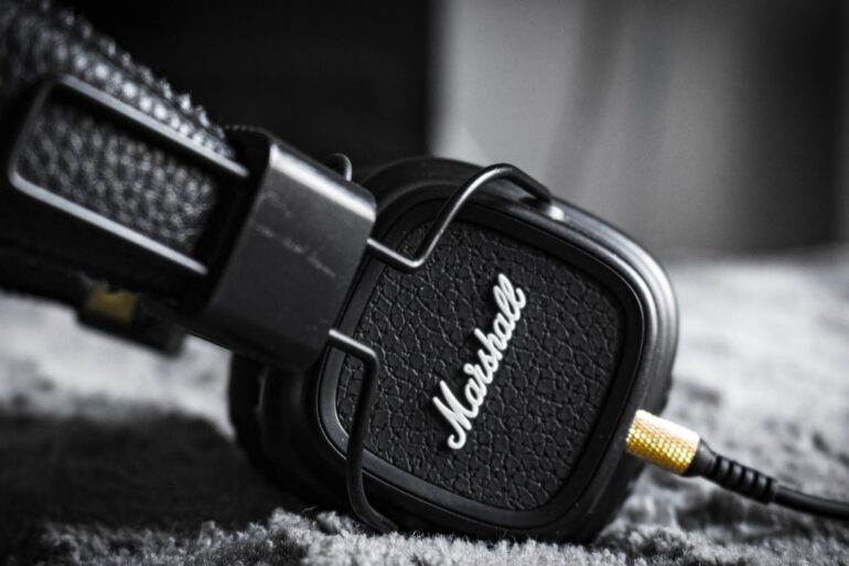 selective focus photography of marshall corded headphones