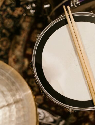 drumsticks over a snare drum