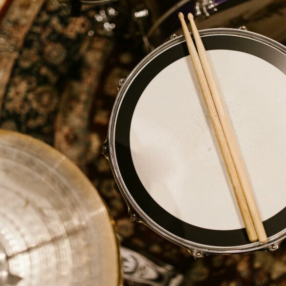 drumsticks over a snare drum