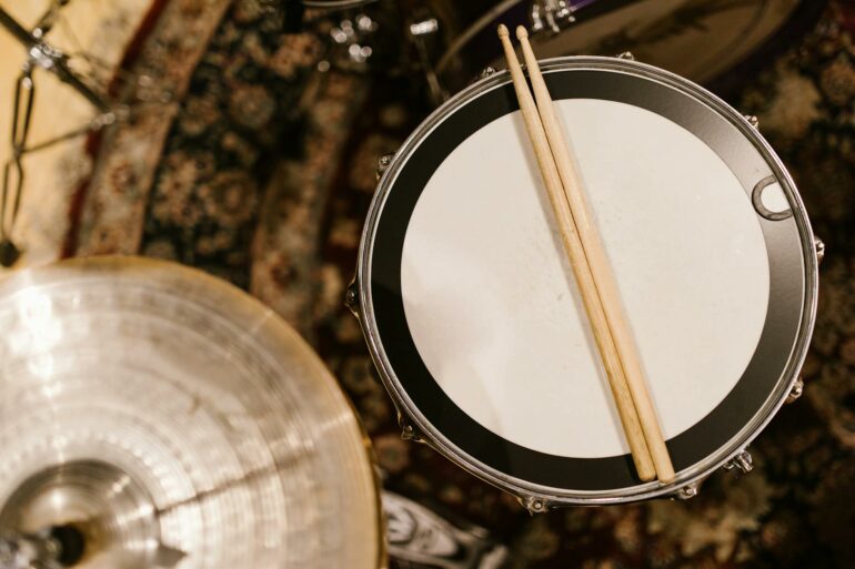 drumsticks over a snare drum